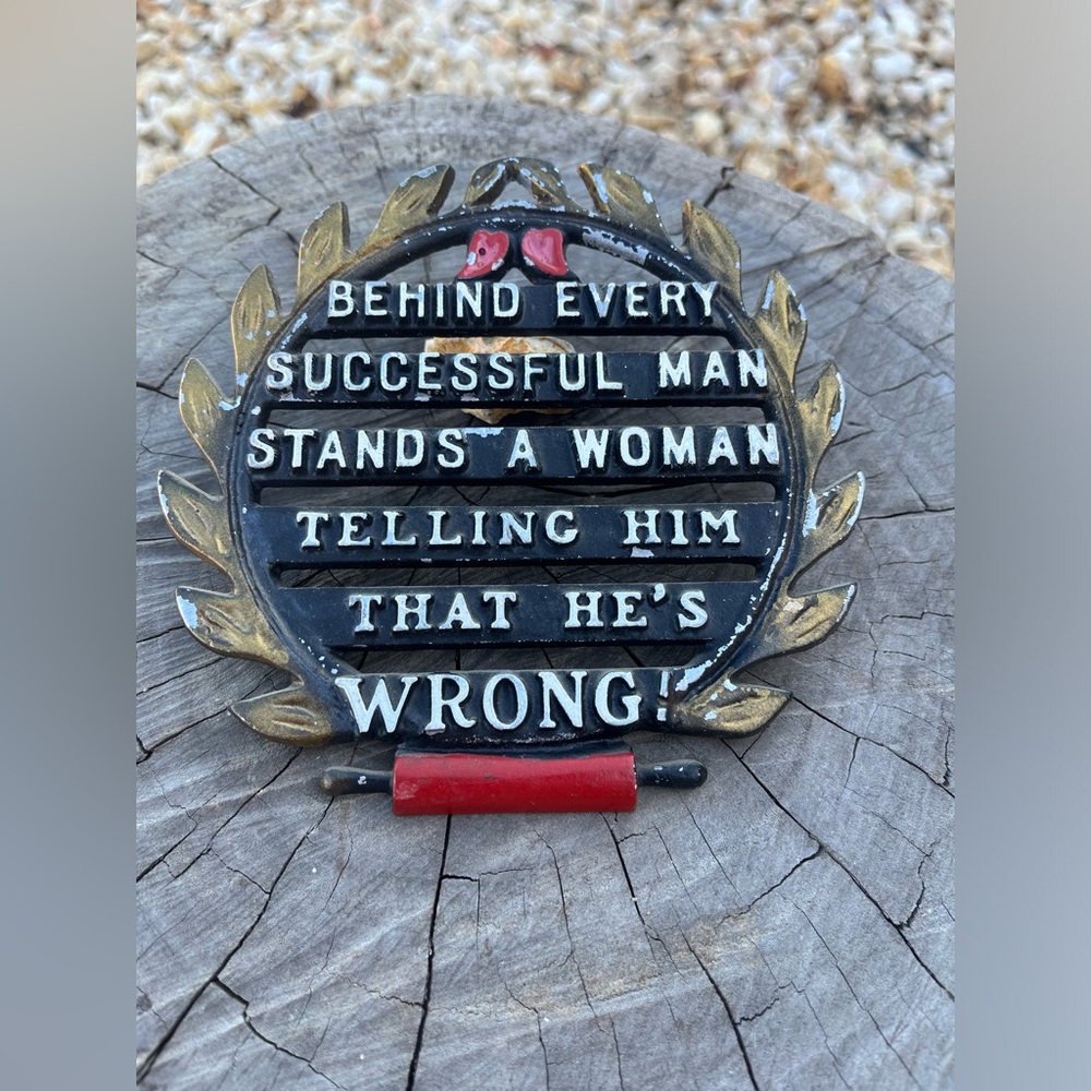 Behind every man is a woman metal sign